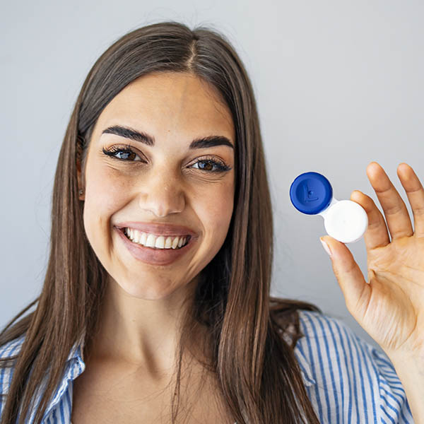 Girl considering the advantages and disadvantages of wearing contacts.